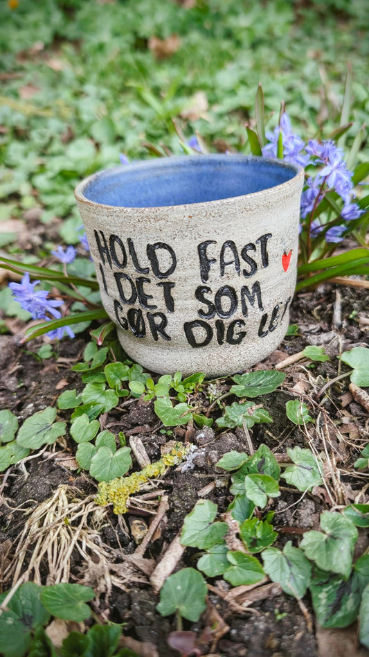 Citat kop - Hold fast i det som gør dig let